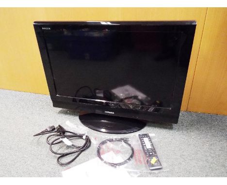 A Toshiba 26 wide screen LCD Television with accessories and manual in original box, the latter in their original sealed pack
