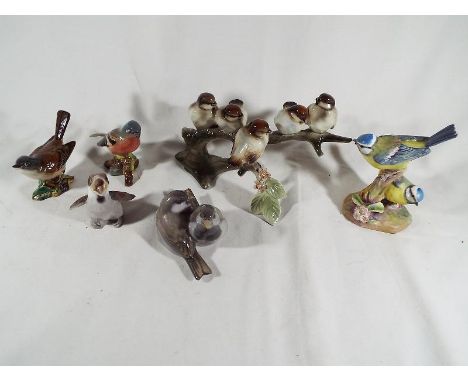 A collection of six ceramic figurines depicting birds to include a Beswick white throat No. 2106, a Beswick Chaffinch No. 991