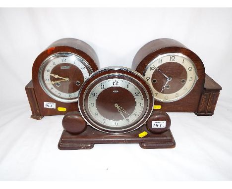 Three mantel clocks, to include an oak cased Art Deco style example with Arabic numerals and Westminster chimes, a further on