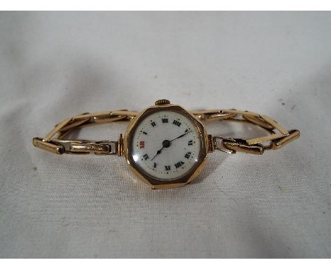 A lady's 9ct gold wristwatch with ceramic face, stamped 375 to the case, boxed Est £100 - £150