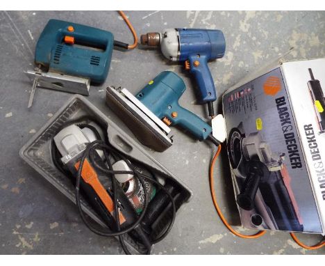 Four Black & Decker power tools