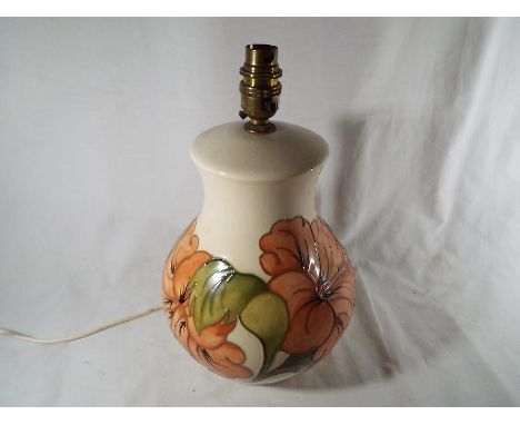 A Moorcroft Pottery large table lamp and shade, the base decorated with pink hibiscus on an ivorine ground, (the base 31 cm h