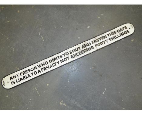 A cast iron sign marked with a warning about shutting the gate, 9.5 cm x 97 cm 