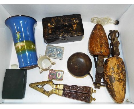 A good mixed lot to include vintage shoe stretchers, bicycle bell, brass nut cracker, bullet lighter, blue Torquay vase depic