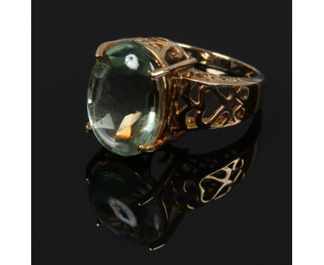 A 9ct gold dress ring set with a large ovoid pale green gem stone, size N 1/2.