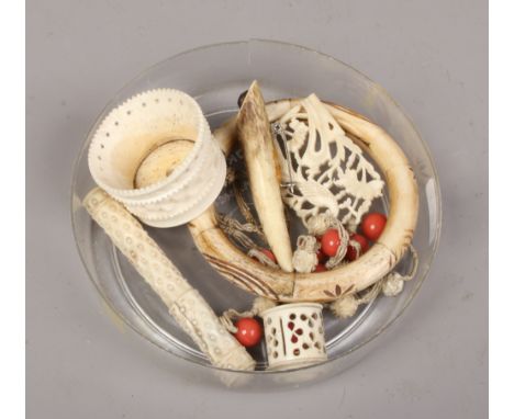 A quantity of carved bone and ivory collectables including pendant on chain strung with carved coral beads, bangle, sewing ac