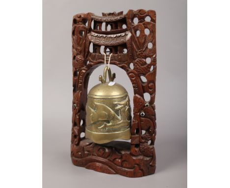 A Chinese bronze prayer bell on carved hardwood stand.
