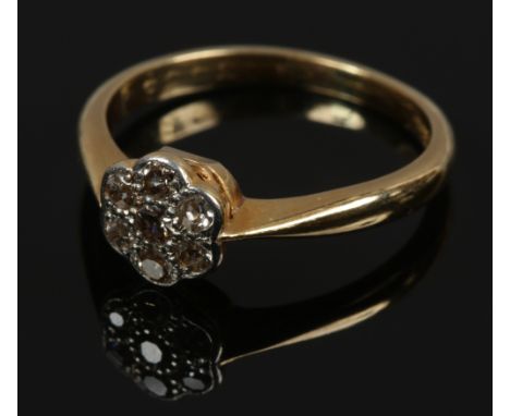 An 18ct gold and platinum diamond daisy cluster ring, size L1/2.