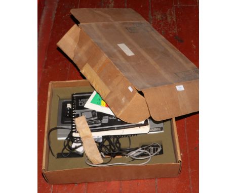 A retro radio shack TR 5-80 micro computer system keyboard and power supply, along with level 1 users manual.