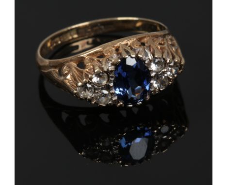 A 9ct gold dress ring set with blue and white stones in a boat shaped setting, size N.