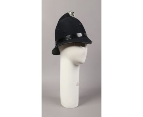 A shop mannequin head and a fancy dress police helmet.