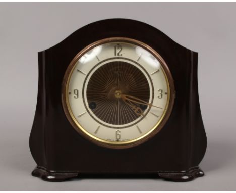 A Bakelite cased Smiths 8 day mantle clock with part silvered dial chiming on a coiled gong complete with pendulum and key.