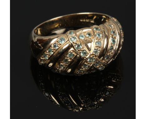 A 9ct gold dress ring of bombe form set with 42 small emeralds, size N.