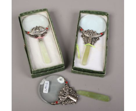 Three white metal and jade coloured hardstone magnifying glasses.Condition report intended as a guide only.Handle loose on on