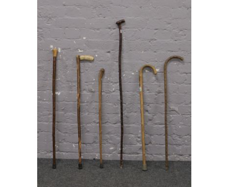 A bundle of six walking sticks including thumb stick.