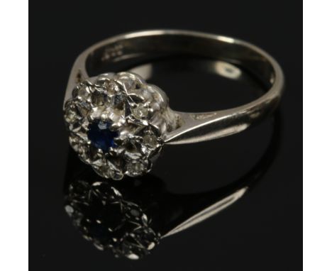 An 18ct gold sapphire and diamond cluster ring, size L1/2.