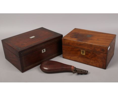 Two Victorian wooden boxes including a mother of pearl inset example, along with a leather mounted powder flask.