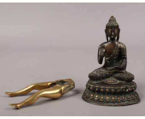 A bronze figure of Buddha, along with a novelty set of brass nut crackers by Peerage.