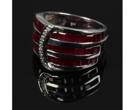 A 9ct white gold Art Deco style ruby and diamond dress ring, of buckle form, size N.