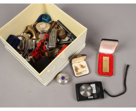 A box of collectables to include multi tools, coins, Zaima lighter etc.