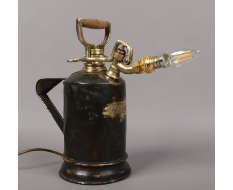 A painted brass pressure spray converted to novelty lamp.