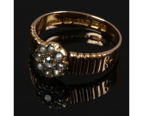 A 15ct gold seed pearl and diamond floriform set ring with reeded shoulders, size M.