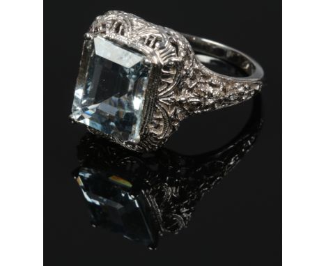 A 14ct white gold emerald cut aquamarine ring, aquamarine approx 11 x 9.6mm with pierced shoulders, size N.