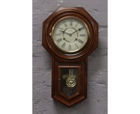 A regulator A drop dial wall clock.