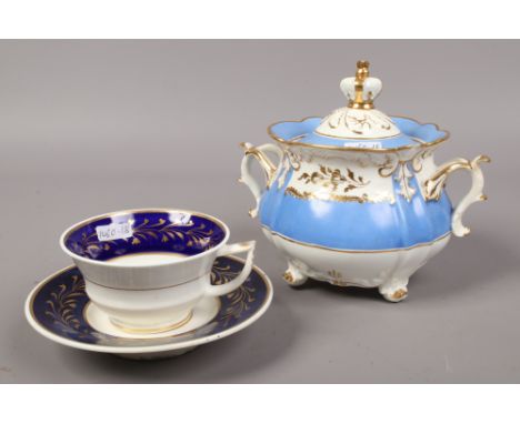 A Rockingham sucrier with Periwinkle and gilt decoration and crown finial along with a Rockingham cup and saucer.Condition re