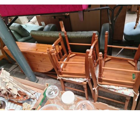 A pine drop leaf table and 4 pine dining chairs. 