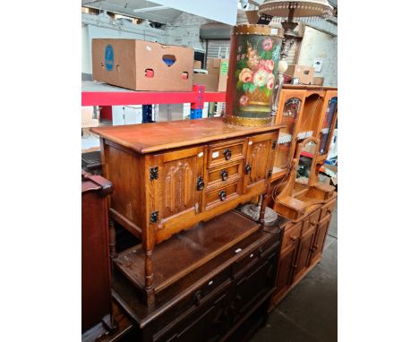 A 1920s oak mirror back sideboard with twist supports, an oak linenfold cupboard, painted stickstand and a metal standard lam