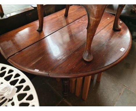 A 19th century mahogany drop leaf table with extra leaf and a light oak nest of tables 