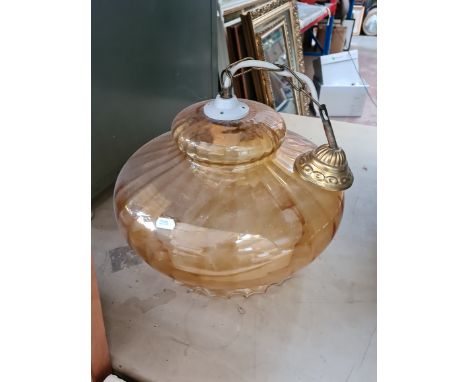An amber coloured glass ceiling light shade fitting.