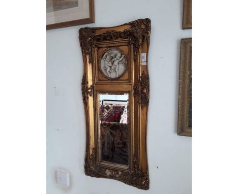 A vintage gilt framed mirror with plaster relief of cherubs, 39cm x 85cm overall. 
