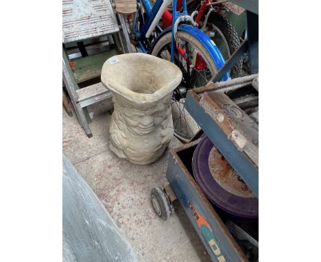 A concrete planter in shape of a Toby jug. 