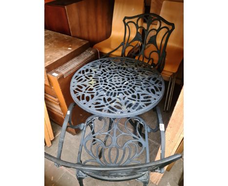 A metal garden table and 2 chairs. 