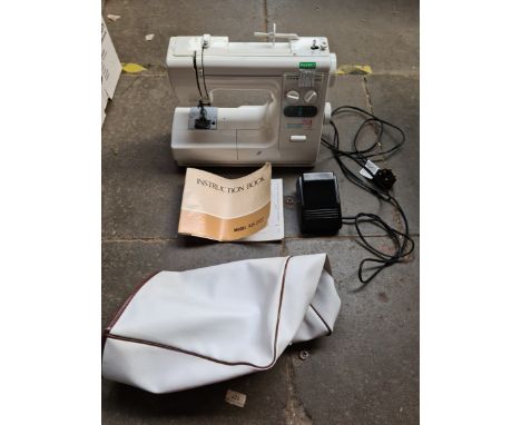 An electric Janome sewing machine with pedal and instructions manual, model number MS 2522