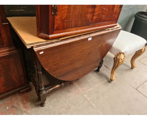 An 18th century oak drop leaf table. 