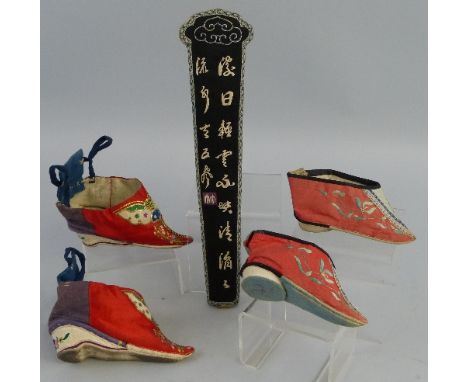 A Chinese chopstick case, of tapering oval sleeve form embroidered in white with Chinese characters on a black ground, 31cm l