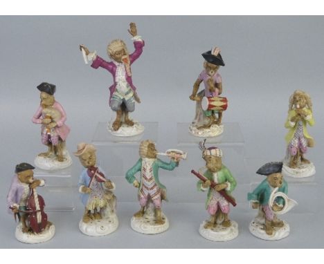 Nine German monkey bandsmen, comprising conductor, two playing stringed instruments, drummer and five playing wind instrument