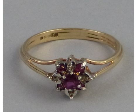 A ruby and diamond cluster ring, comprising central ruby surrounded by diamonds and rubies on 9ct gold shank, size N