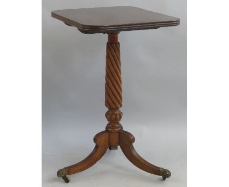 A mahogany tripod table, the reeded edged oblong tilt top on wrythen turned stem and reeded downswept legs with brass toes an