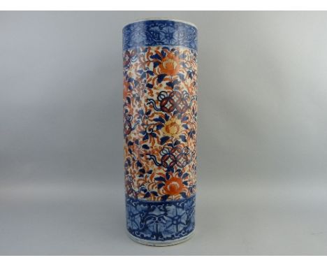 A Japanese Imari stick stand, of cylindrical form painted all over with flowers and leaves in blues and reds within blue and 