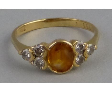 A citrine and diamond ring, comprising central oval orange citrine flanked to either side by three diamonds set on 18ct gold 