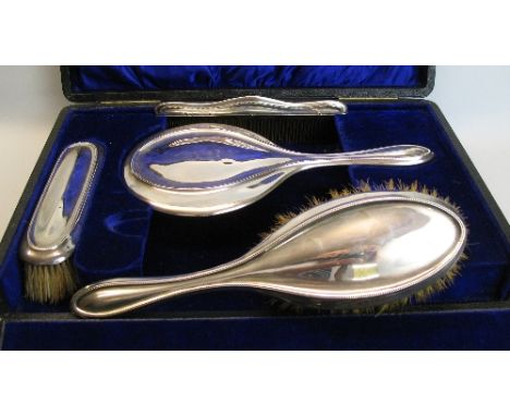 A four piece brush set, comprising hair brush, clothes brush, comb and hand mirror, the circular bevel edged plate in moulded