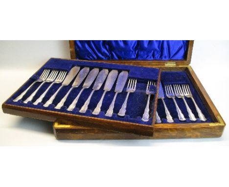 A cased set of fish eaters, for twelve settings having wavy hafts in oak canteen, Sheffield 1912, 28.21ozs (one fork missing)