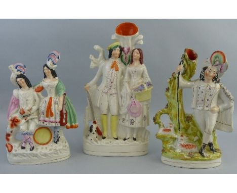 Two Victorian Staffordshire flat back spill vase groups, comprising a huntsman with his arm around a lady and a dog at his fe