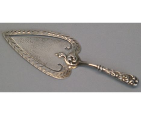 A sterling silver bookmark, in the form of a presentation trowel inscribed "Compliments of R Wallace & Sons, MFG Co, Silversm