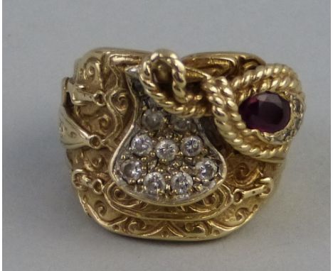 A 9ct gold saddle ring, set with diamonds and a single ruby, size W, 28.5grams 