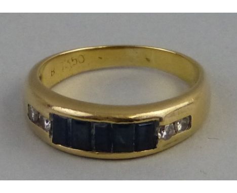 A sapphire and diamond ring, comprising five baguette cut dark blue sapphires flanked to either side by two small diamonds se